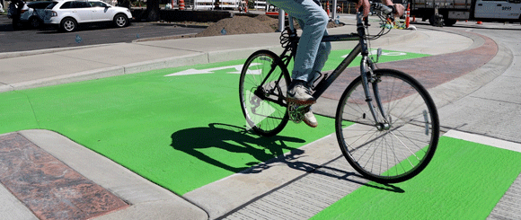 A bike riding through the new bike lane at a roundabout.