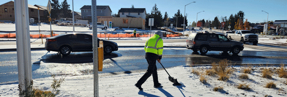 Streets crew shoveling a sidewalk.