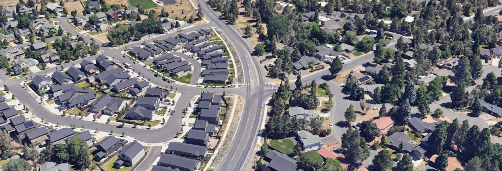 Drone shot of project area, Bulter Market Rd and Wells Acres Rd. intersection. Houses and trees surround the streets.