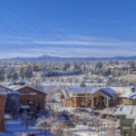 Old Mill District in Bend with snow in winter. Blue skies, fresh, white snow on buildings.