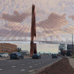 Image of bridge spanning the Bend Parkway. Cars are driving on the parkway.