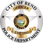 Bend Police Department badge logo. Gray star behind the State or Oregon Seal and black text surrounding