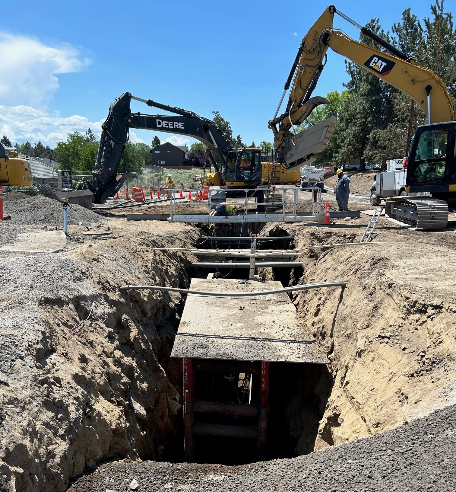 deep sewer trench work with various utility lines crossings