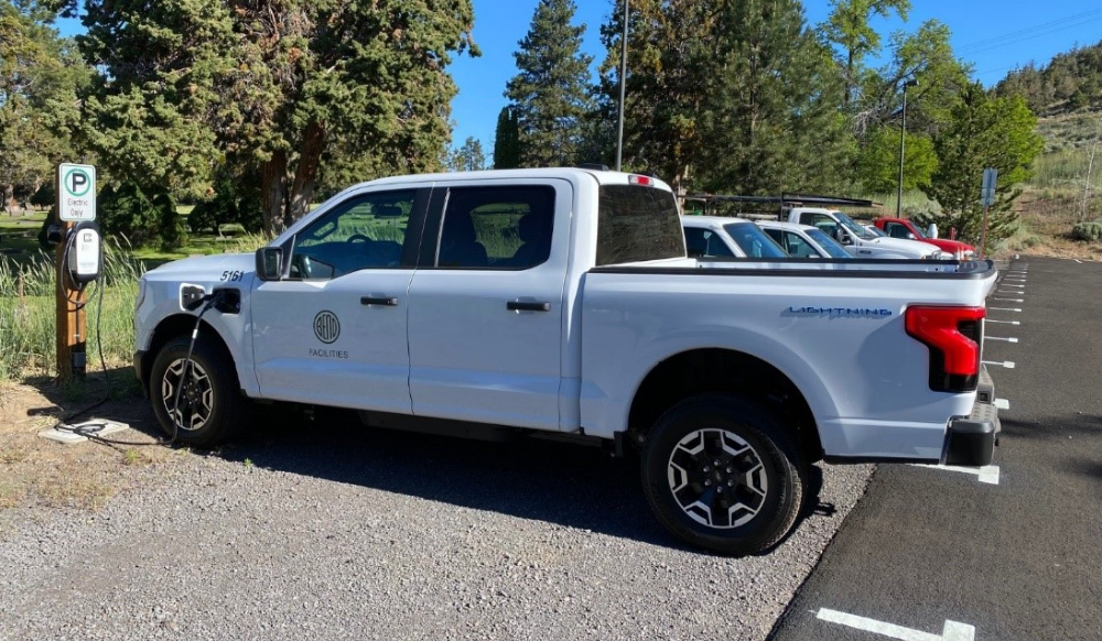 White electric truck with City of Bend logo on the door.