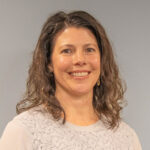 Gina is of light complexion with shoulder length brown hair.