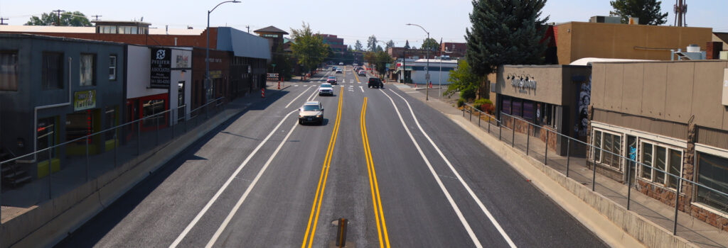 Drone shot of Greenwood Ave, looking west. Roads with cars and buildings.