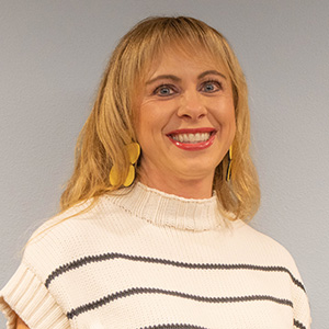 Megan is of light complexion and has shoulder length blonde hair.