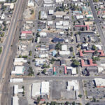 Satellite view of project area. Looking north through Bend, Bend Parkway through the middle, streets and crossings, buildings, and houses shown.