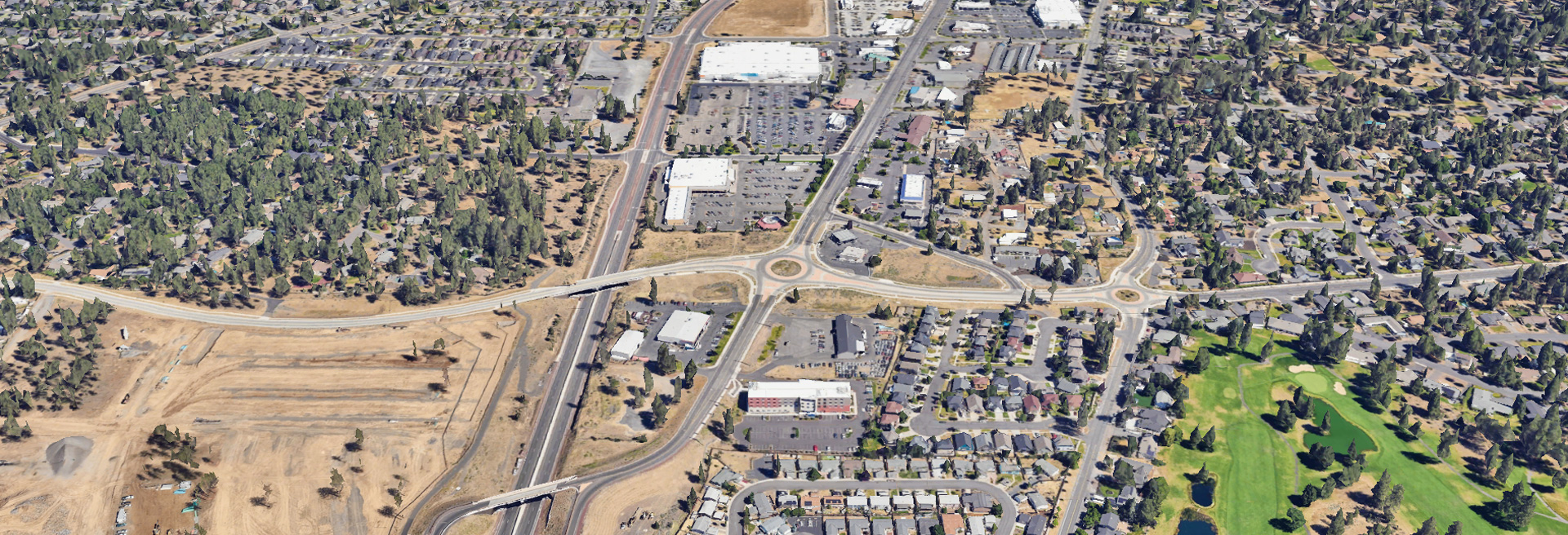 Overhead shot of Murphy Crossing. Roads, houses, trees and more. US Highway 97 runs through the middle.