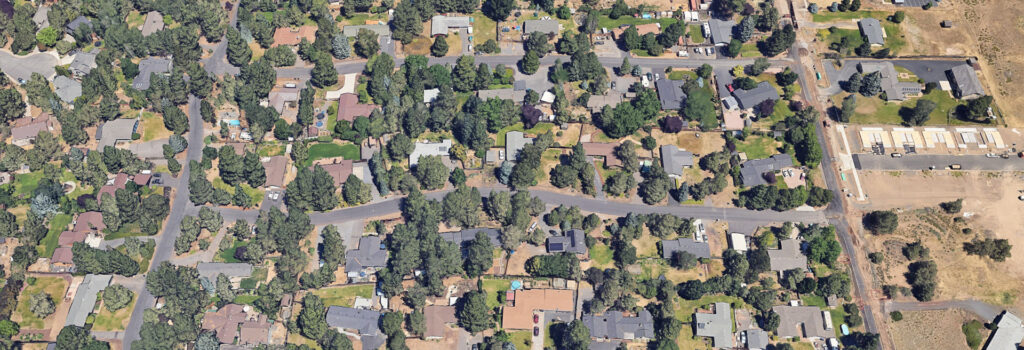 Satellite view of project area. Houses, streets, and trees shown.