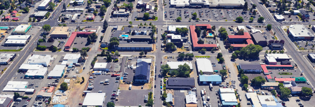 Drone shot of project area looking east. Streets, buildings, houses.