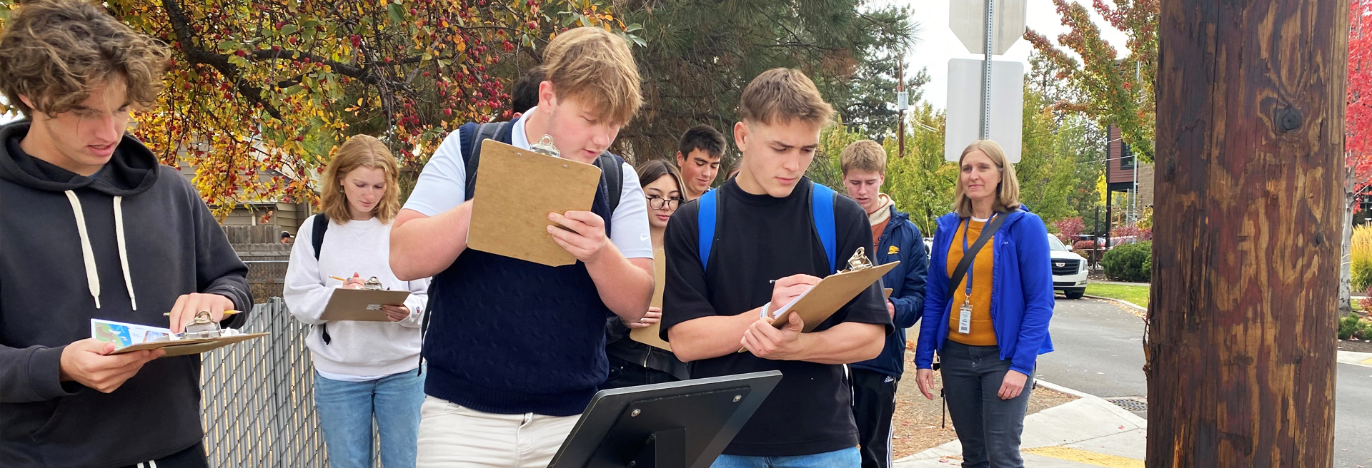 Students looking at clipboards while on the walking tour.