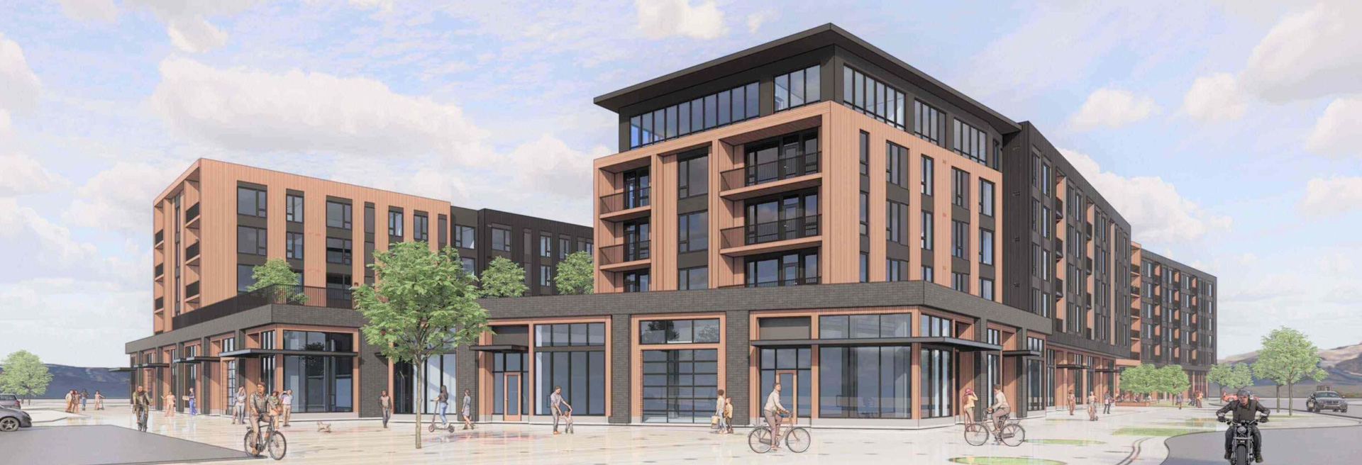 Rendering of a multi-unit large mixed-use building. Is five stories tall, gray and tan facade.