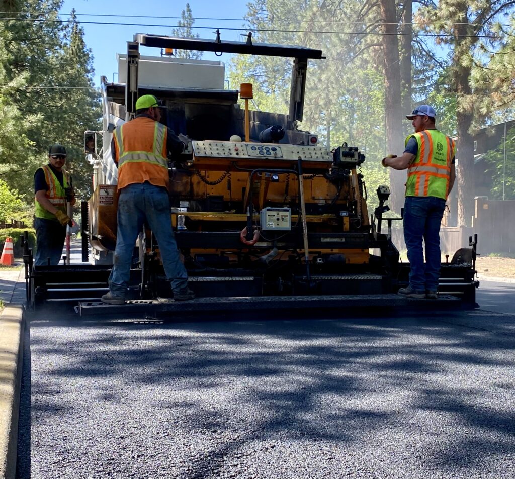 City Street crews run equipment in paving work.