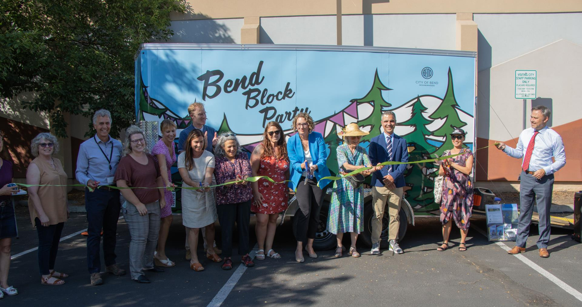 Group of people standing in front of the Bend Block Party trailer.