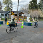 Bike riders riding down a city street.