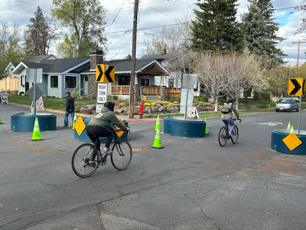 Bike riders riding down a city street.