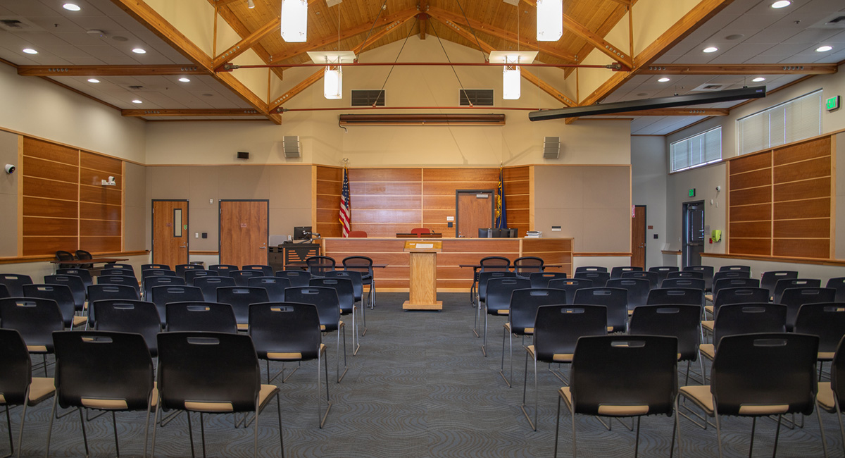 Courtroom with chairs, a diesis, and a podium.