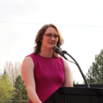 Mayor Melanie Kebler talking behind a podium into a microphone.