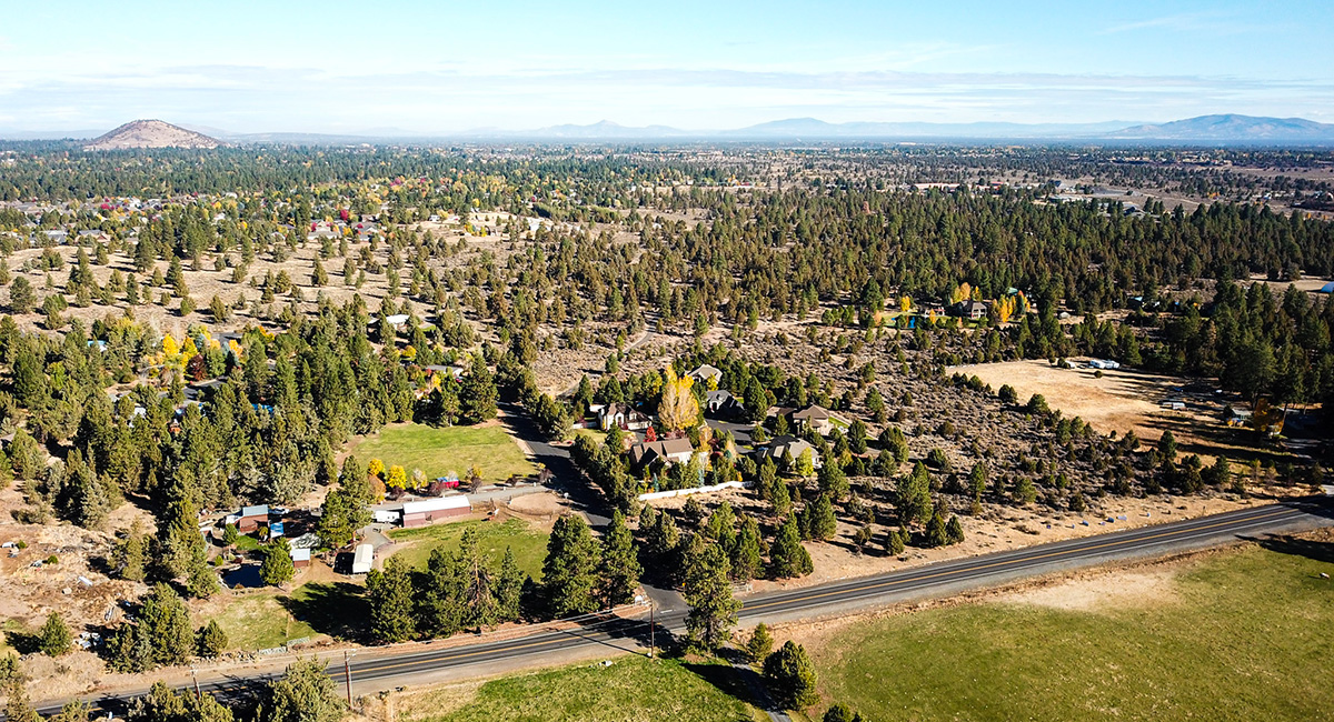 Ariel shot of mostly undeveloped land with trees covering most of the land.