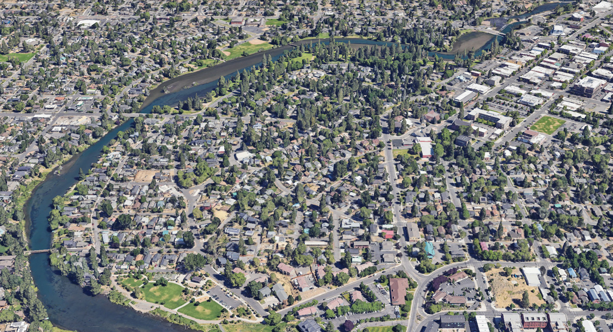 Arial shot of the Old Bend Parking District. Streets and homes with trees.