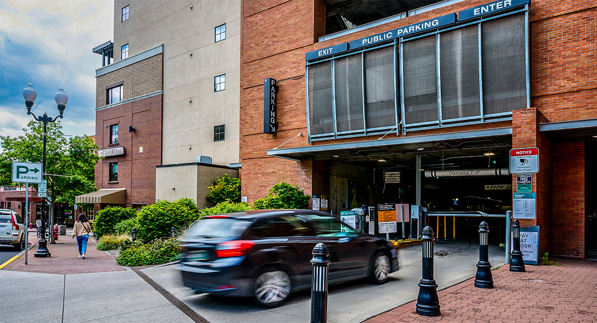 Car pulling into a parking garage from the street.