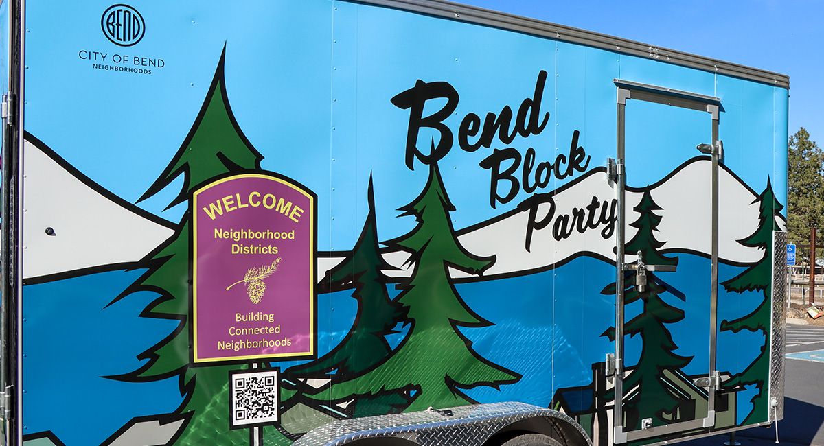Exterior of the Block Party Trailer with a mural of mountains and trees.