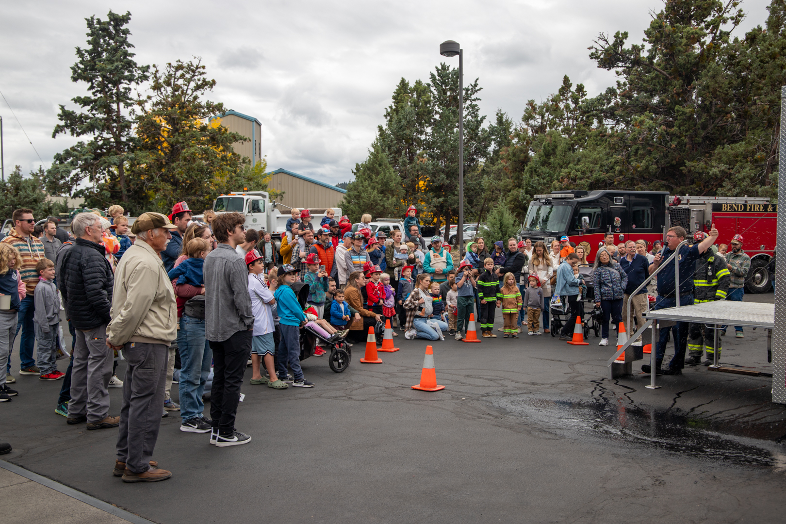 Families and friends gather around a safe cooking with fire demonstration at the 2025 Open House