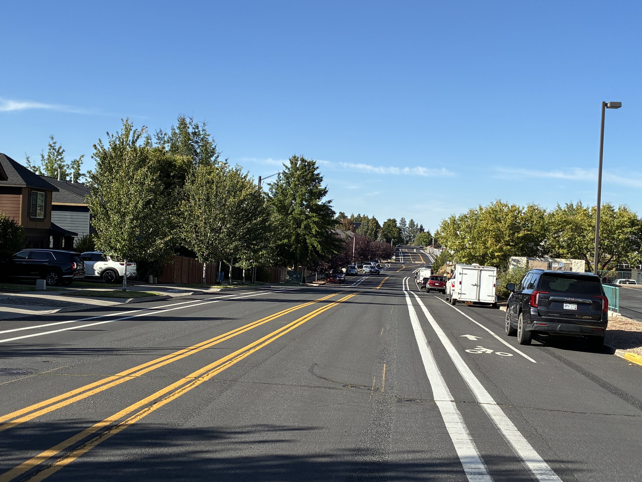 A corridor with commercial and residential alongside a road with bike lanes.