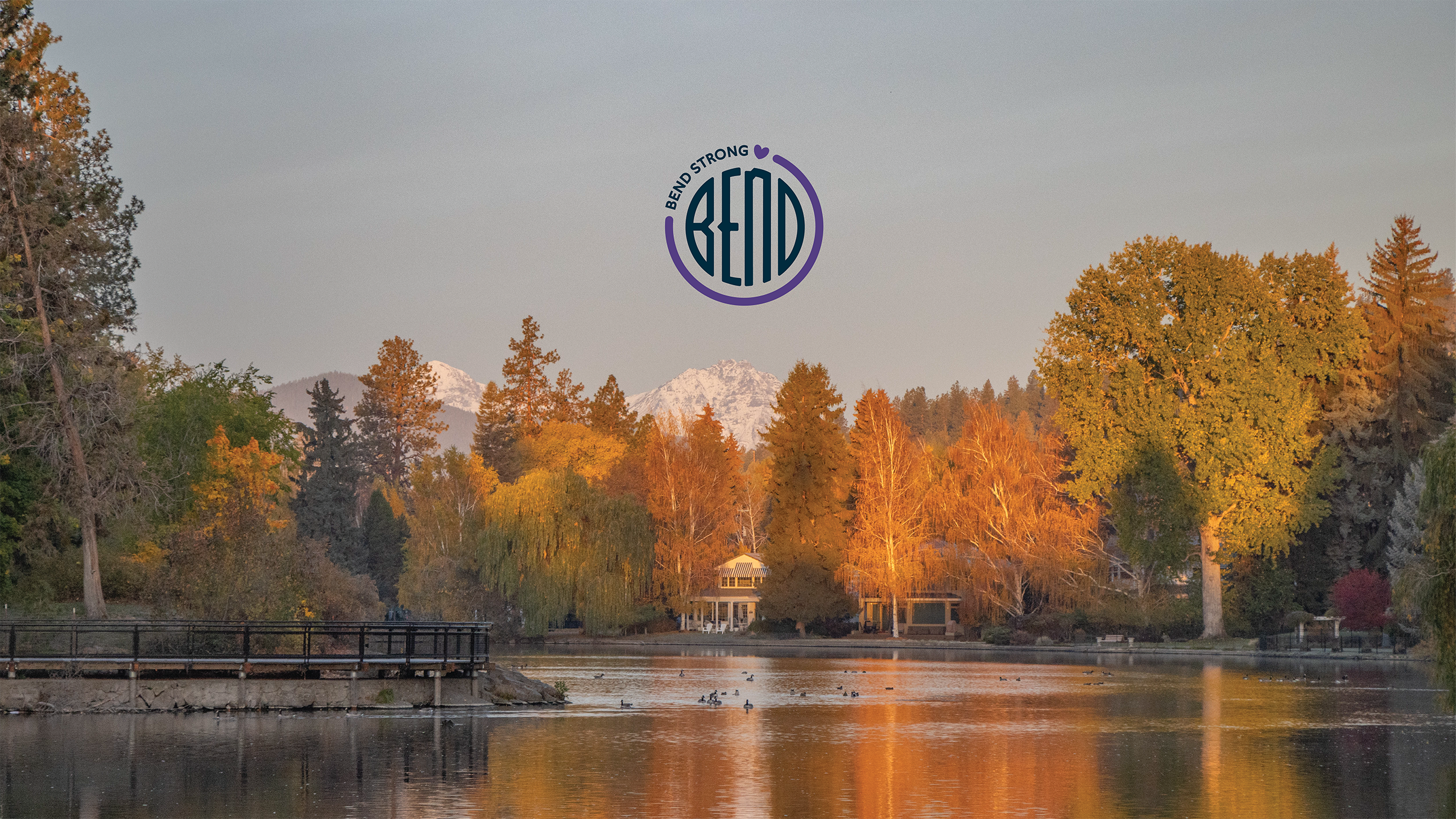 Drake park overlooking Mirror Pond with mountains in the background.