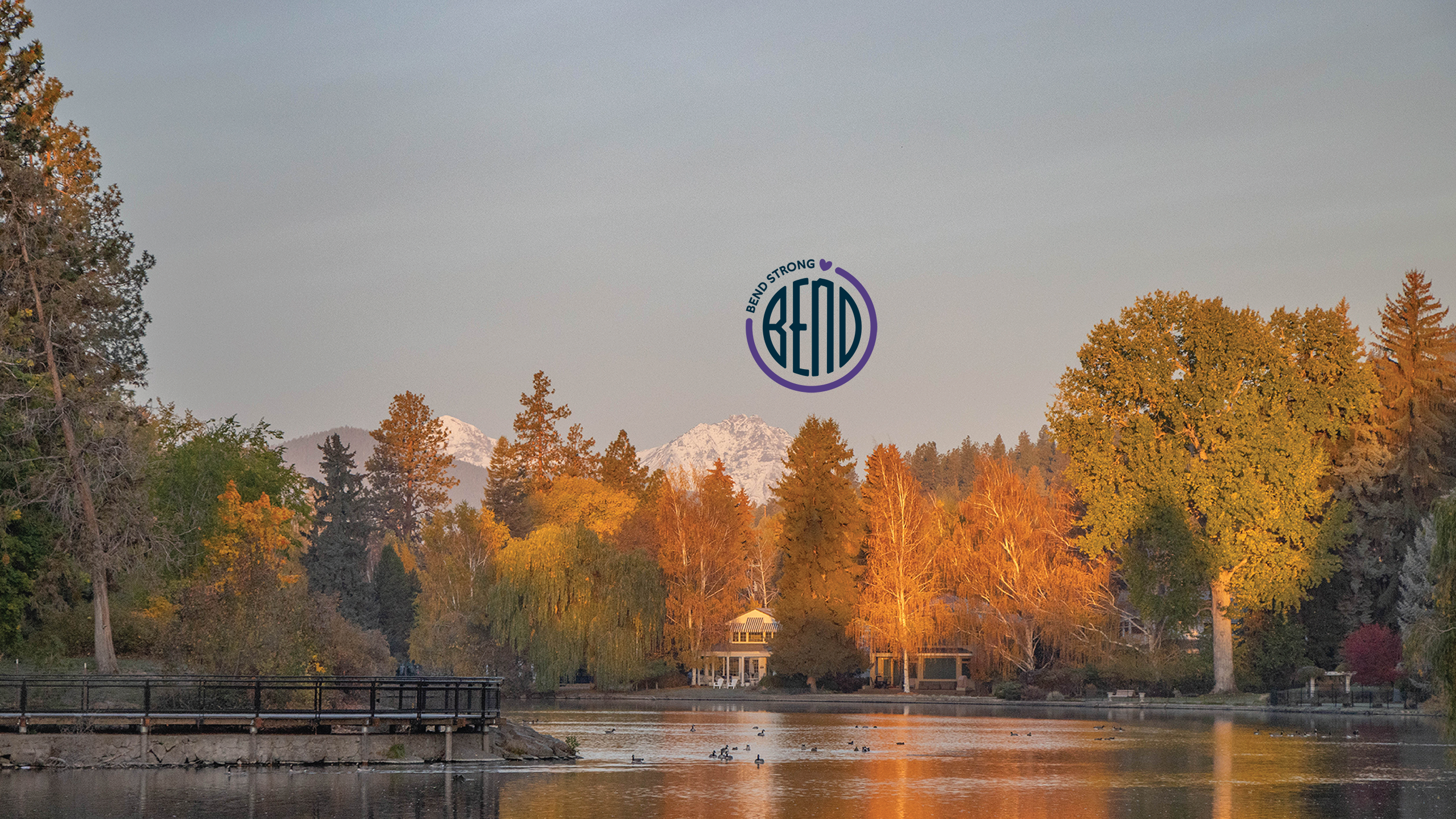 Drake Park overlooking Mirrior Pond with mountains in the background.